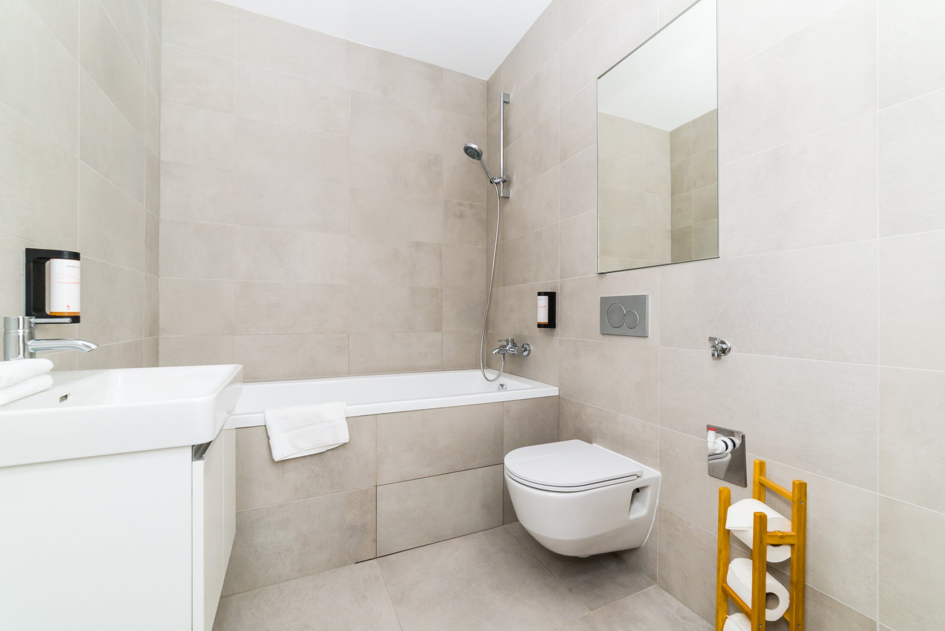 Pure designed bathroom with the toilet, where you can enjoy an evening bath in a comfortable bathtub.